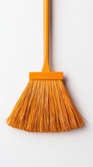 A vibrant orange broom isolated on a white background, ideal for cleaning tasks.