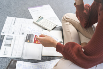 Business financial concept, stressed asian young woman hand checking list with bill for calculate...