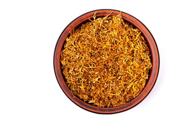 Fermented yellow tobacco in a brown plate on a white background
