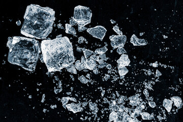 A crushed ice shards on a black background.Particles of crushed ice spread away.