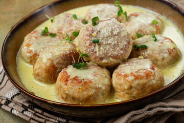 chicken meatballs, in cream sauce, garnished with parmesan cheese, and microgreens, homemade, no...