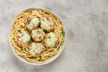 spaghetti with chicken meatballs, with cream sauce, and parmesan cheese, and decorated with microgreens, homemade, no people,