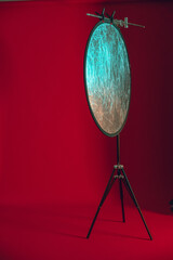 reflector on a stand on a red background