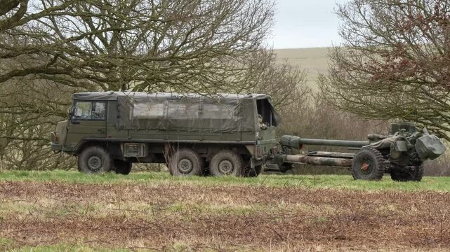 British army bae systems, Puch, Daimler, Pinzgauer High-Mobility All-Terrain 6x6 vehicle towing a 105mm Light Artillery Gun on a military exercise