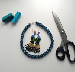 Blue beaded harness and peacock earrings. Lovely hand-woven jewelry