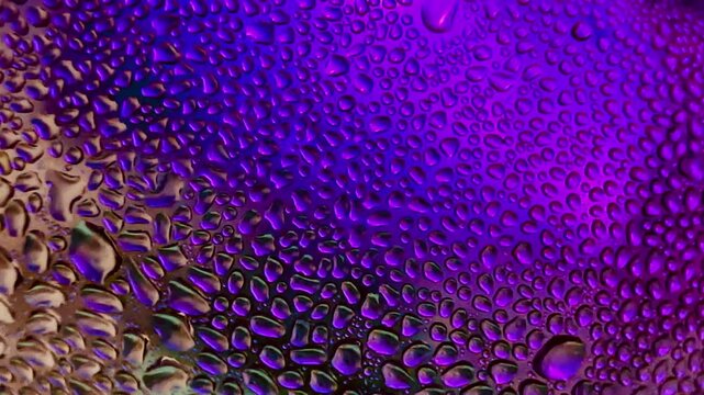 Close-up of water drops on metal surface in high resolution showing condensation of water droplets on metal surface. Intricate patterns and different sized water droplets create a beautiful abstract