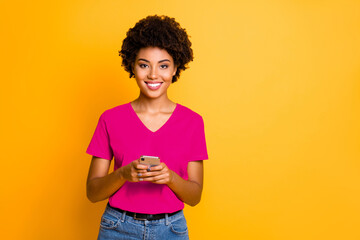 Photo of charming attractive gorgeous fascinating black girlfriend holding phone with her hands...