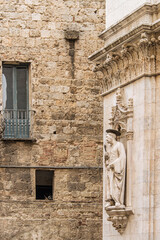 Fototapeta premium Facade of old buildings in the historical center of Siena, the UNESCO World Heritage Centre, unchanged for 13-14 centuries, with its medieval streets looked like in the early Middle Ages. Italy, 2019