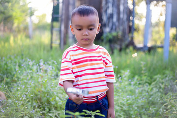Kids exploring in forest with a magnifying glass