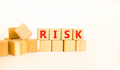 Risk symbol. Concept word Risk on beautiful wooden blocks. Beautiful white table white background. Business, lifestyle, support and risk concept. Copy space.