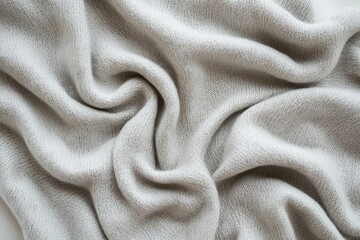 Obraz premium A close-up of a soft, luxurious cashmere blanket, showing the intricate weave and gentle folds, creating a warm and inviting texture for a cozy and comforting experience.