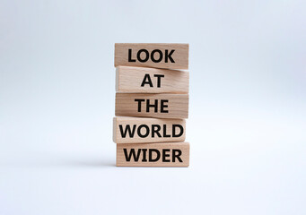 Look at the world wider symbol. Wooden blocks with words Look at the world wider. Beautiful white background. Business and Look at the world wider concept. Copy space.