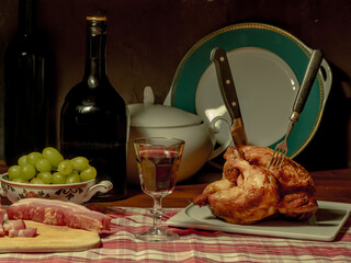 A stylized antique still life with a grilled chicken, a glass of red wine and lard.	(rotisserie chicken)

