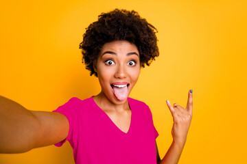 Photo of attractive cheerful sweet pretty curly trendy wavy foolish girlfriend sticking her tongue...