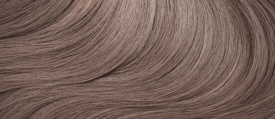 Blond hair close-up as a background. Women's long light brown hair. Beautifully styled wavy shiny...