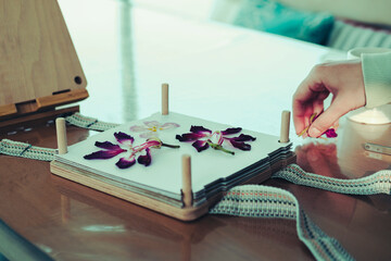 pressing flowers process, ypung hand arranging plants for drying in flower press kit, lovely hobby...