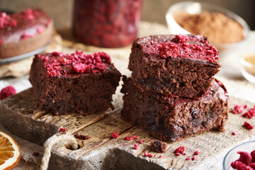 Three pieces of homemade gluten-free brownies made with red kidney beans, oat flakes, chocolate and freeze-dried raspberries