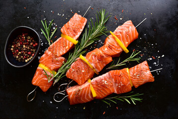 Fresh marinated salmon skewers kebab with spices. Top view with copy space.