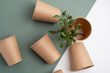 Eco-friendly disposable paper tableware. Paper cup, wooden forks, recycling. Copy space
