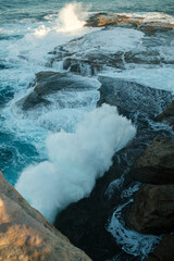 waves crashing on rocks