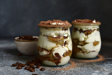 Delicious italian coffee dessert tiramisu in vintage jars.