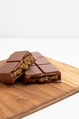 Bar of dark, milk chocolate with filling, Dubai chocolate. Delicious chocolate close-up with nut filling
