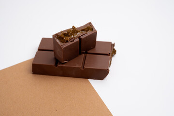 Bar of dark, milk chocolate with filling, Dubai chocolate. Delicious chocolate close-up with nut filling
