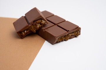 Bar of dark, milk chocolate with filling, Dubai chocolate. Delicious chocolate close-up with nut filling

