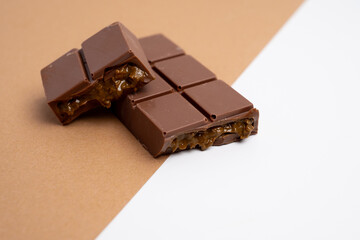 Bar of dark, milk chocolate with filling, Dubai chocolate. Delicious chocolate close-up with nut filling