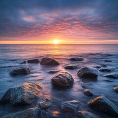 Naklejka premium Sunrise over calm ocean rocks; tranquil seascape