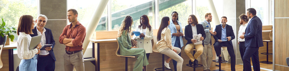 Group of diverse business people men and women chatting after a meeting. Company employees or group...
