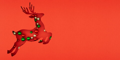 paper cut Red Reindeer with Christmas Ornaments on Textured Red Background