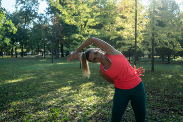 A beautiful slim athletic girl in sportswear with snakeskin prints performs a set of exercises....