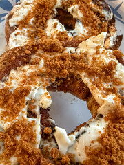 Fototapeta premium Bagel Halves Topped With Sour Cream, Cinnamon, And Crushed Speculaas Cookies