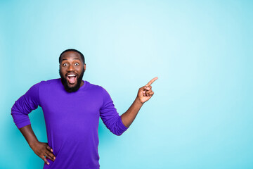 Photo of attractive dark skin business guy toothy smiling indicating finger to empty space advising...