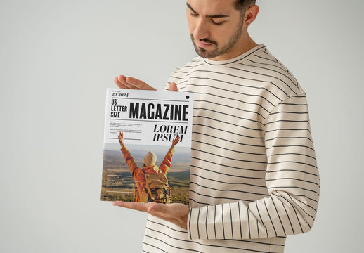 Mockup Of Man Holding Customizable Saddle Stitch Magazine