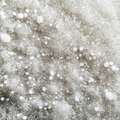 Close-up of sparkling white glitter on a pastel background