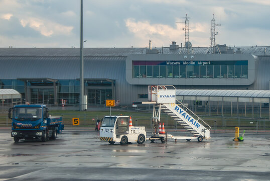 Warsaw Modlin Airport arrival area with Ryanair aircraft boarding stairs with logo.