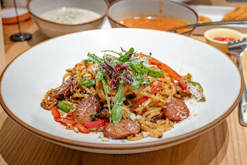 Eating with family in a restaurant, pasta with sausage, small restaurant, pleasure and lifestyle