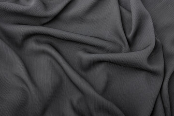 Elegant dark grey fabric texture with soft flowing folds and creases