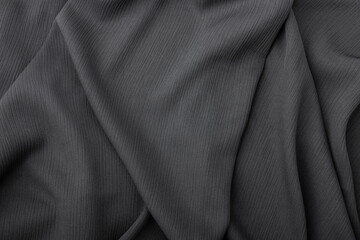 Elegant dark grey fabric texture with soft flowing folds and creases