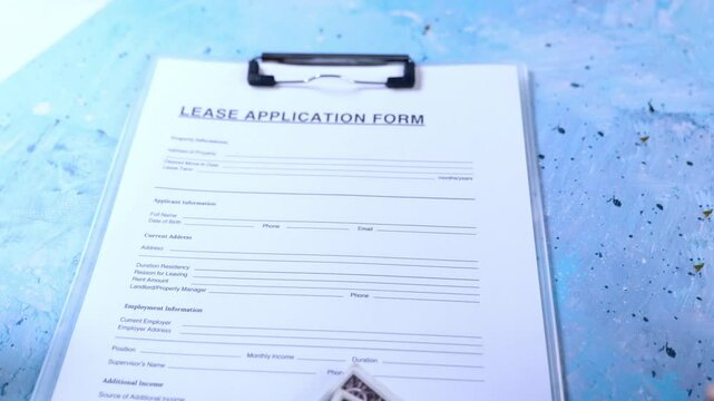 Filling out a lease application form for a new apartment