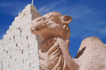 Obraz premium Historic Inca Structures Made of Stone Blocks and Intricate Carvings in Arequipa, Peru Against Blue Sky - Ancient Architecture Representing Rich Cultural Heritage