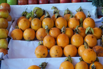 Fresh granadillas on display at a fruit stall in Peru, with vibrant colors and textures for a...