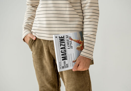 Mockup Of Man Holding Customized Saddlestitch Magazine