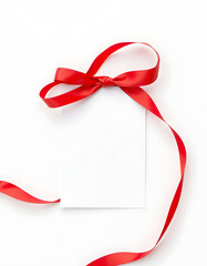 Red satin ribbon and blank card isolated on white, top view, Dynamic motion. with white shades
