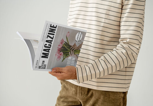 Mockup Of Man Reading Customized Saddlestitch Magazine