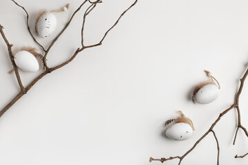 Happy Easter minimalistic composition with decorative eggs and twigs, copy space for your text. 