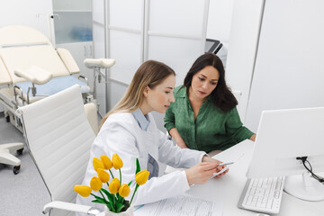 Consultation of gynecologist. Doctor and woman patient is talking in gynecological office during...
