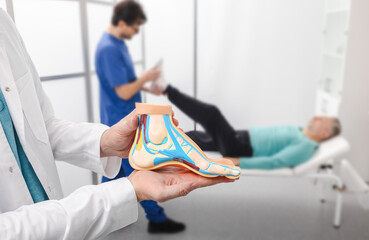 Foot diseases and treatment. Male patient with problem of feet while orthopedic doctor consultation at medical clinic